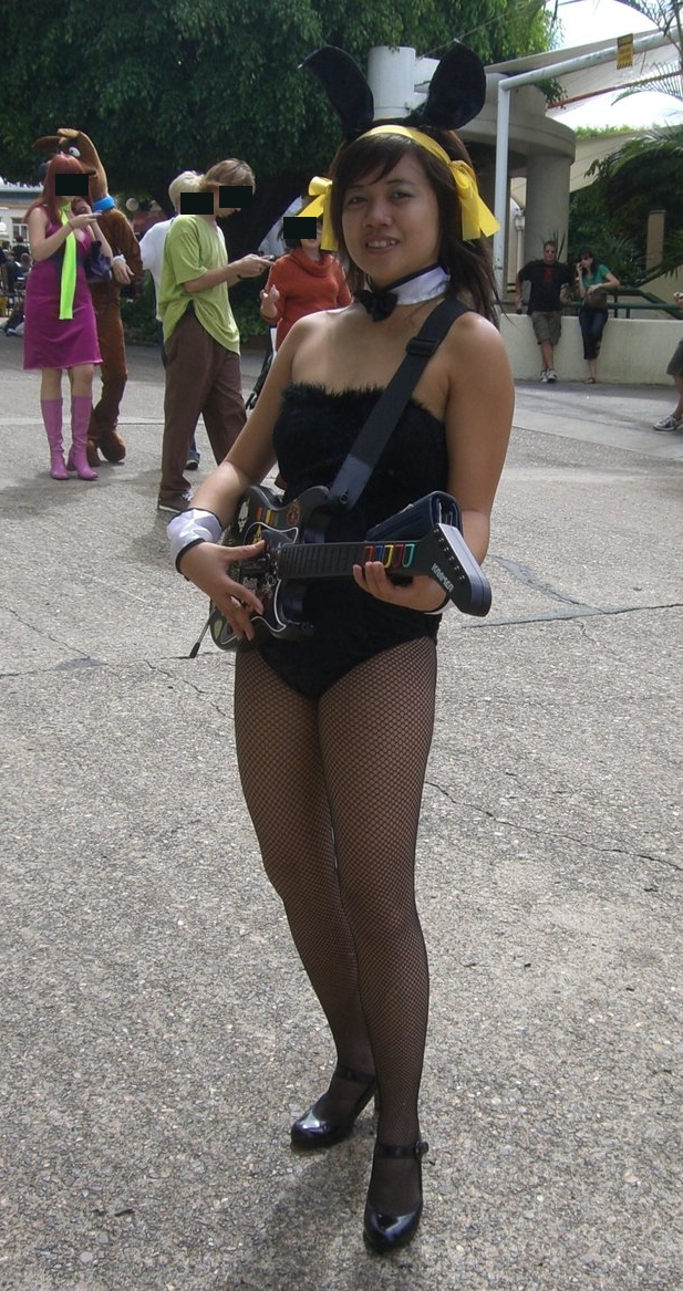 Brunette Asian Bunny Girl wearing Black Fishnet Pantyhose, Sandal High Heels and Black Fur Bodysuit